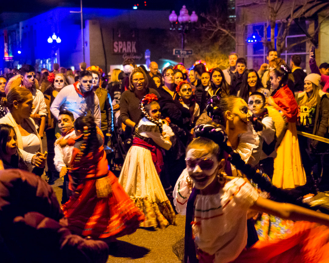 Children dance in traditional dress and makeup